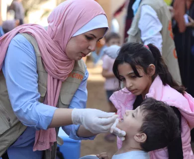 A health worker in Gaza administers a polio vaccination.